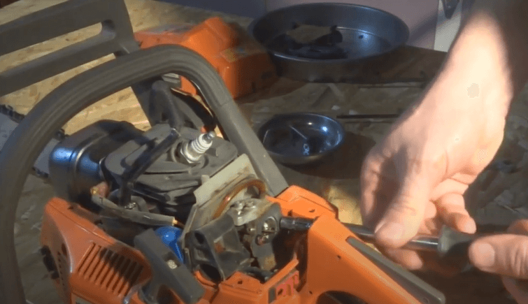 take-out-the-studs-holding-the-carburetor-using-a-screwdriver